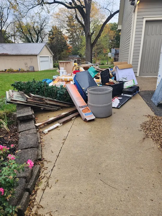 Dumpster being loaded with debris for 12 Yard Dumpster Rental in Medina